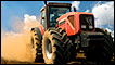 Big red tractor in a field