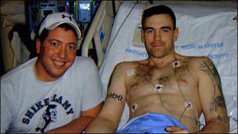 Captain Josh Mantz (right) recovering in intensive care with his best friend (left)