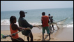 Fishermen on a boat off the shores of a fishing village called Godrich near Freetown