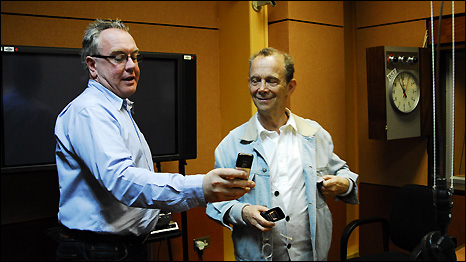 Matthew Bannister and Joel Grey compare results in the Outlook studio. 