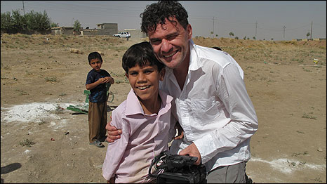 Mark Cousins (right) with child in Goptapa, Iraq