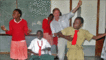 Outlook's Mike Thomson joins in with the children playing 'air' instruments to the band's performance.