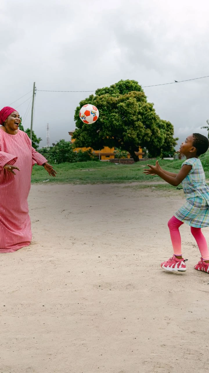 A grandmother plays with her granddaughter