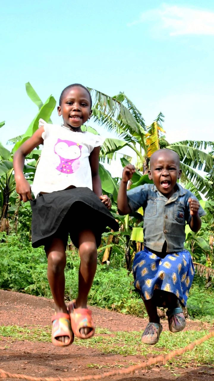 Two children jump with joy