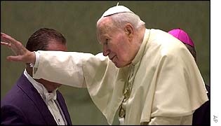 Pope John Paul II waves to worshippers at the Vatican on Monday