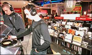 Customers listening to records in an HMV store.