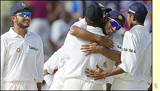 Rahul Dravid of India congratulates bowler Harbhajan Singh after he took the wicket of  Ridley Jacobs
