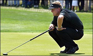 Colin Montgomerie lines up a putt at the Deutsche Bank Open 
