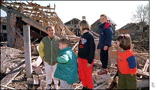 Children play in bomb-damaged property