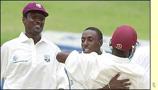 Windies cricketers celebrate an Indian wicket