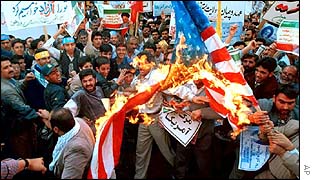 Iranian protesters burn US flag