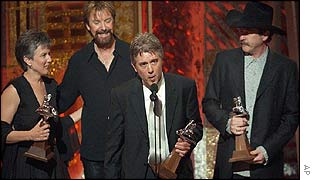 Kix Brooks, right, and Ronnie Dunn, second left, listen as producer Michael Merriman, centre, accepts the award for video of the year for Only in America