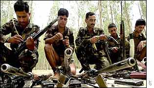Indian soldiers clean their weapons