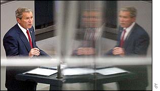 President Bush, reflected in glass, addresses the Bundestag