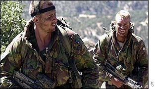 British Royal Marine Commandos move away from a supply drop on a hill in southeast Afghanistan