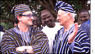 Bono (left) and Paul O'Neill in traditional costumes presented to them by the villagers in northern Ghana,