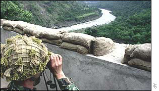 A Pakistani soldier looks towards Indian positions
