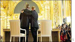 George Bush and Vladimir Putin embrace after signing a landmark arms treaty at the Kremlin