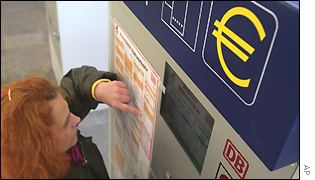 Woman looks at euro prices in German train station