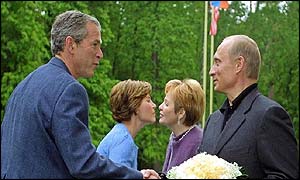 President Bush, Laura Bush are welcomed by Russian President Vladimir Putin and his wife Lyudmila at an informal dinner