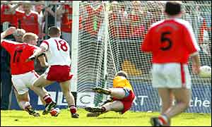 Armagh replacement Barry Duffy shots past Peter Ward