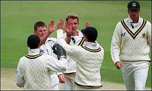 Andy Harris takes a wicket