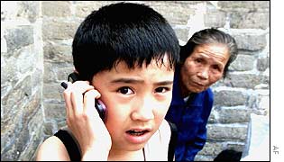 Child on mobile phone at the Great Wall of China