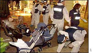 Israeli policeman searching after bomb blast