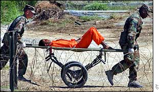 US guards carry suspect off for interrogation