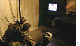 Indian border security troops in Srinagar watch Musharraf's address