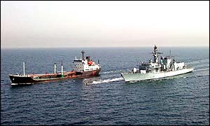 HMS Portland moves alongside the smugglers' ship MV Devo