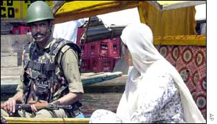 An Indian border patrol guard and a woman in Srinagar
