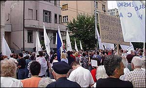 A small rally of Milosevic supporters in Belgrade wave placards