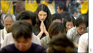 Relatives mourn during Buddhist ceremony, 31 May 2002