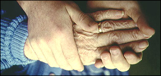An elderly person and helper