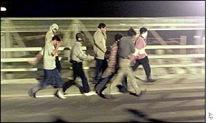 Illegal immigrants try to broach security at the French end of the Channel Tunnel