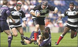 Kris Chesney (centre) powers towards the Scotland line
