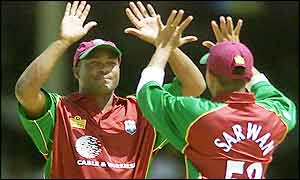 Brian Lara celebrates taking a catch