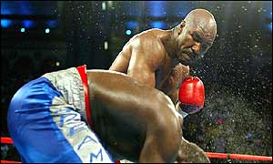 Evander Holyfield lands a right hand to the head of Hasim Rahman