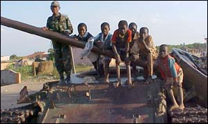 Carlos (l) plays with civilian children on a disused tank 