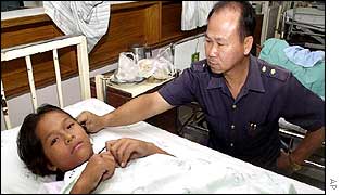 Durain Homeseat tends his daughter Kanjana Homeseat, 13, who was injured in the shooting