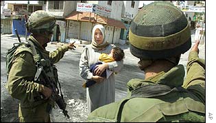 A Palestinian mother and Israeli soldiers
