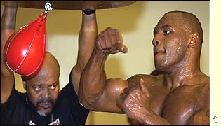 Tyson works out under the gaze of Stacey McKinley