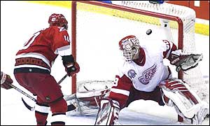 Francis slips the puck past Hasek to win game one