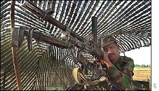 An Indian army soldier takes aim