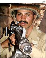 A Pakistani soldier with a machine gun in a bunker near the Kashmir border