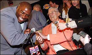 Magic Johnson (left) greets fellow NBA great George Mikan