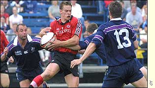 Scotland tacklers close in on a Canada East attacker
