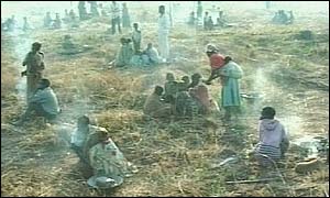 People sitting in an empty field