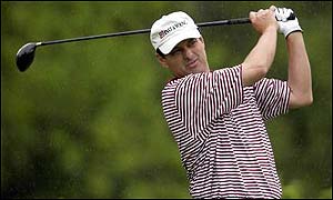 Loren Roberts watches the flight of his ball off the tee